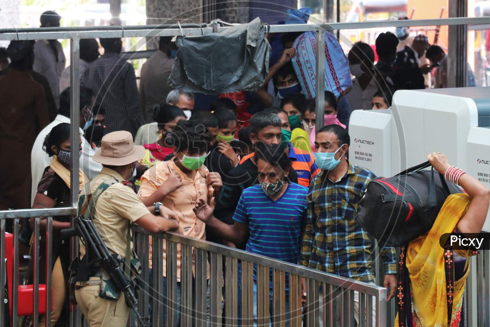 People wearing protective masks arrive at a railway station, amid the spread of the coronavirus disease (COVID-19), in Mumbai, India, November, 2020.