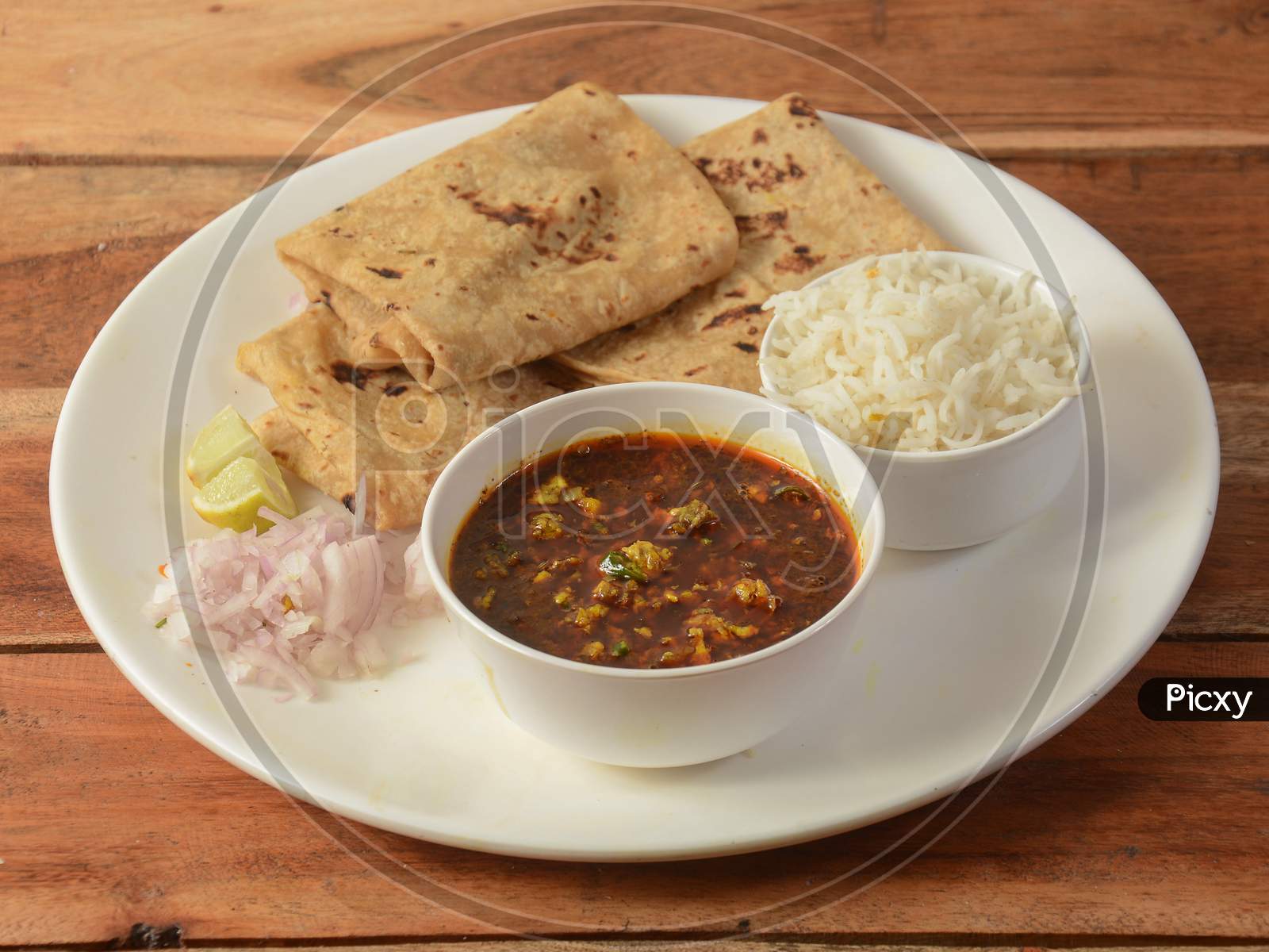 Assorted Indian Food Egg Gravy,Chapati And Boiled Rice On Wooden Background. Dishes And Appetizers Of Indian Cuisine