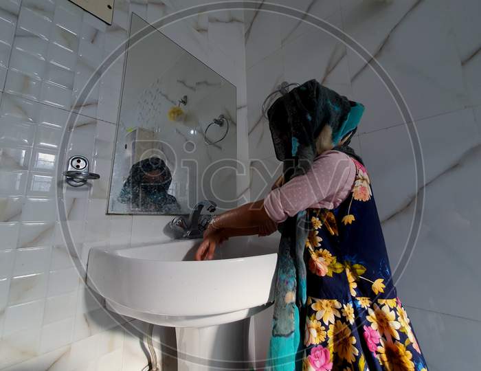 Washing Hands In Bathroom By Masked Children During Coronavirus Pandemic. Hand Wash Mask Wearing And Using Sanitiser Are Recommended By World Health Organisation.