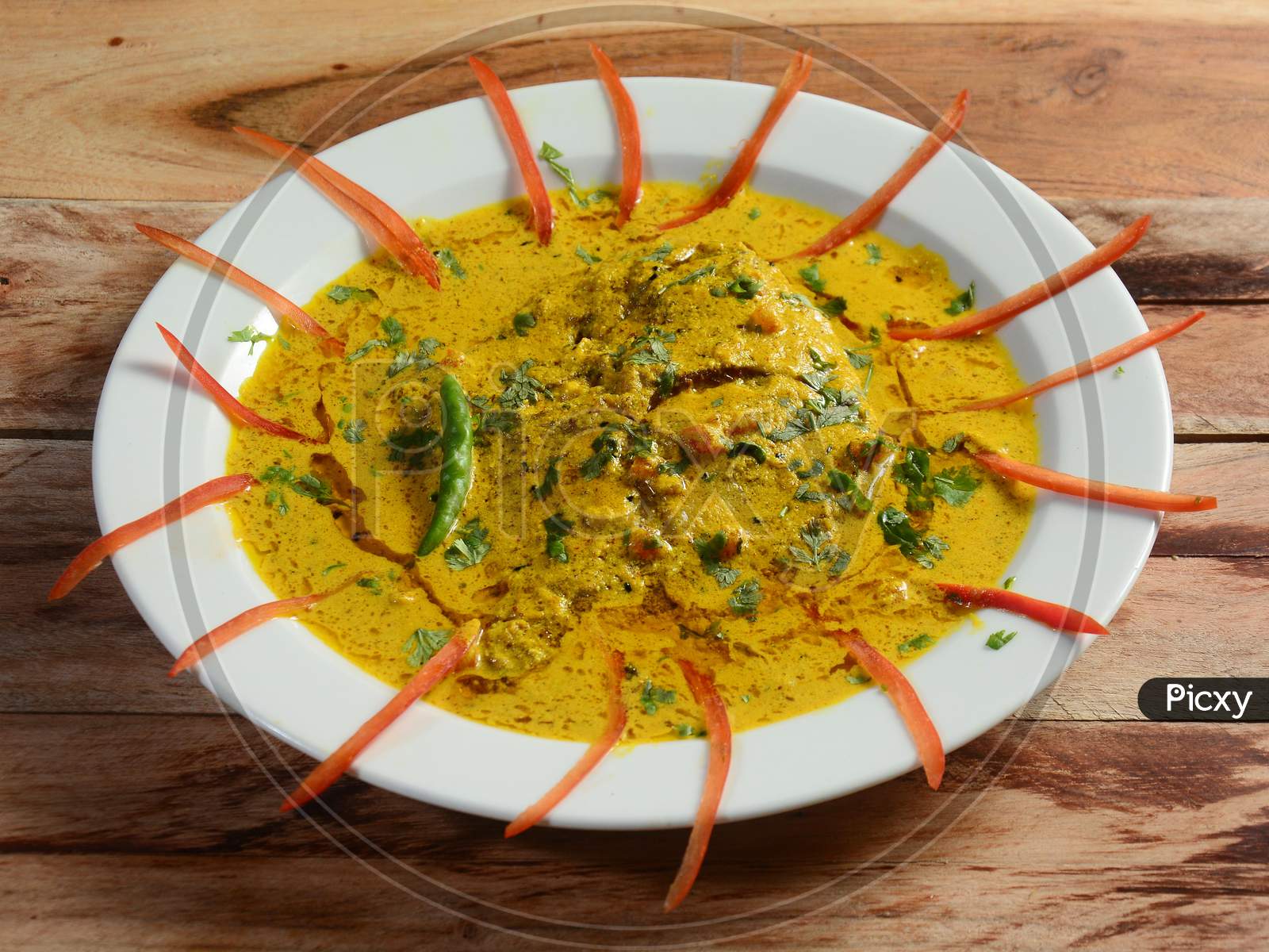Spicy Hot Kerala Masala Fish Curry Prepared Using Coconut Milk And Spices, Pomfret Fish In South India Style Served On A Ceramic White Plate, Selective Focus