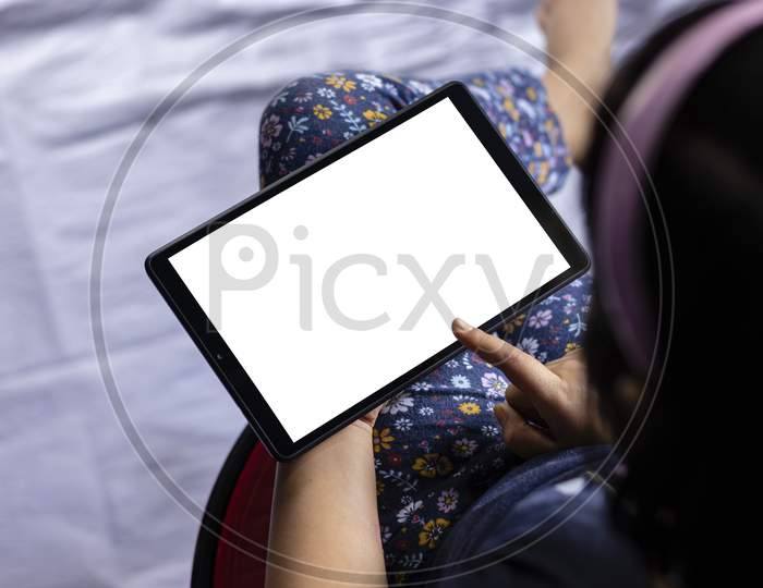 An Indian Girl Child Holding Tablet With White Blank Screen In Hand