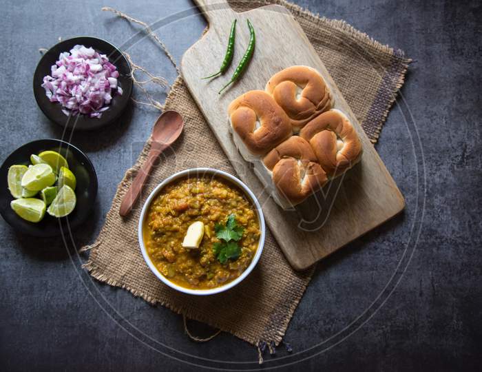 Top view of popular Indian fast food pav bhaji and condiments