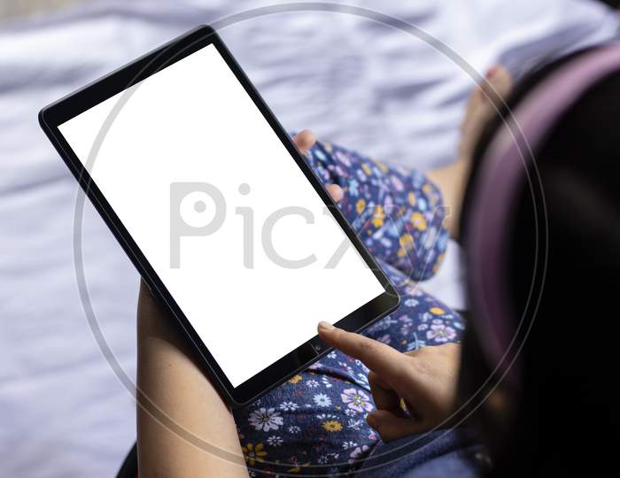 An Indian Girl Child Holding Tablet With White Blank Screen In Hand