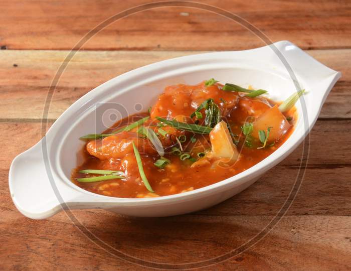 Fish Hot Garlic Sauce Served Over Rustic Wooden Background