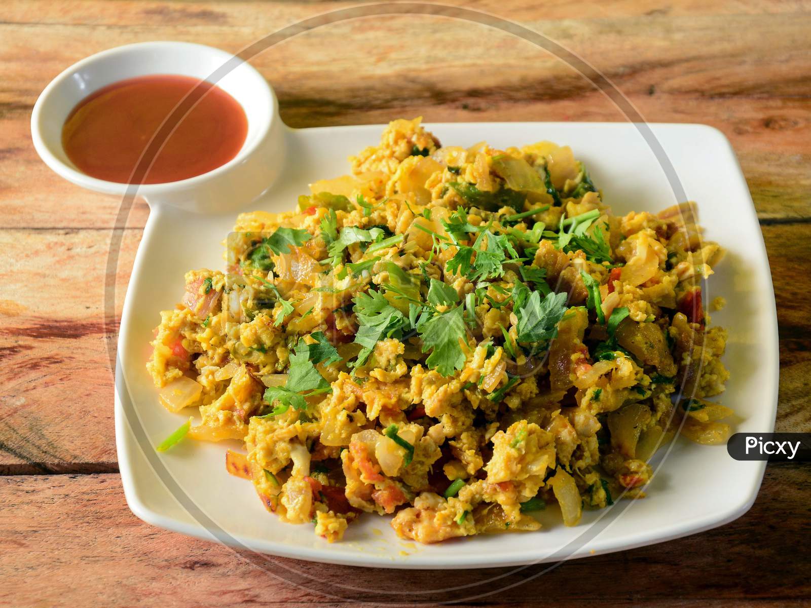 Egg Bhurji, A Preparation Of Scrambled Eggs With Tomatoes,Onions,Gingers And Green Chilies Served With Tomato Sauce, Selective Focus