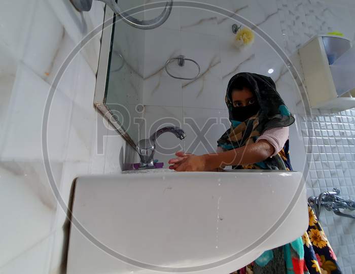 Washing Hands In Bathroom By Masked Children During Coronavirus Pandemic. Hand Wash Mask Wearing And Using Sanitiser Are Recommended By World Health Organisation.