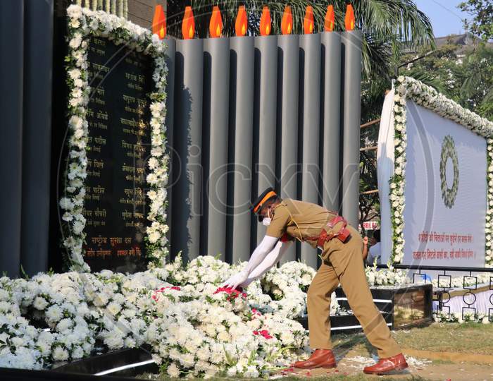 A police officer pays his respects at a memorial to mark the 12th anniversary of the November 26, 2008 attacks, in Mumbai, India November 26, 2020.