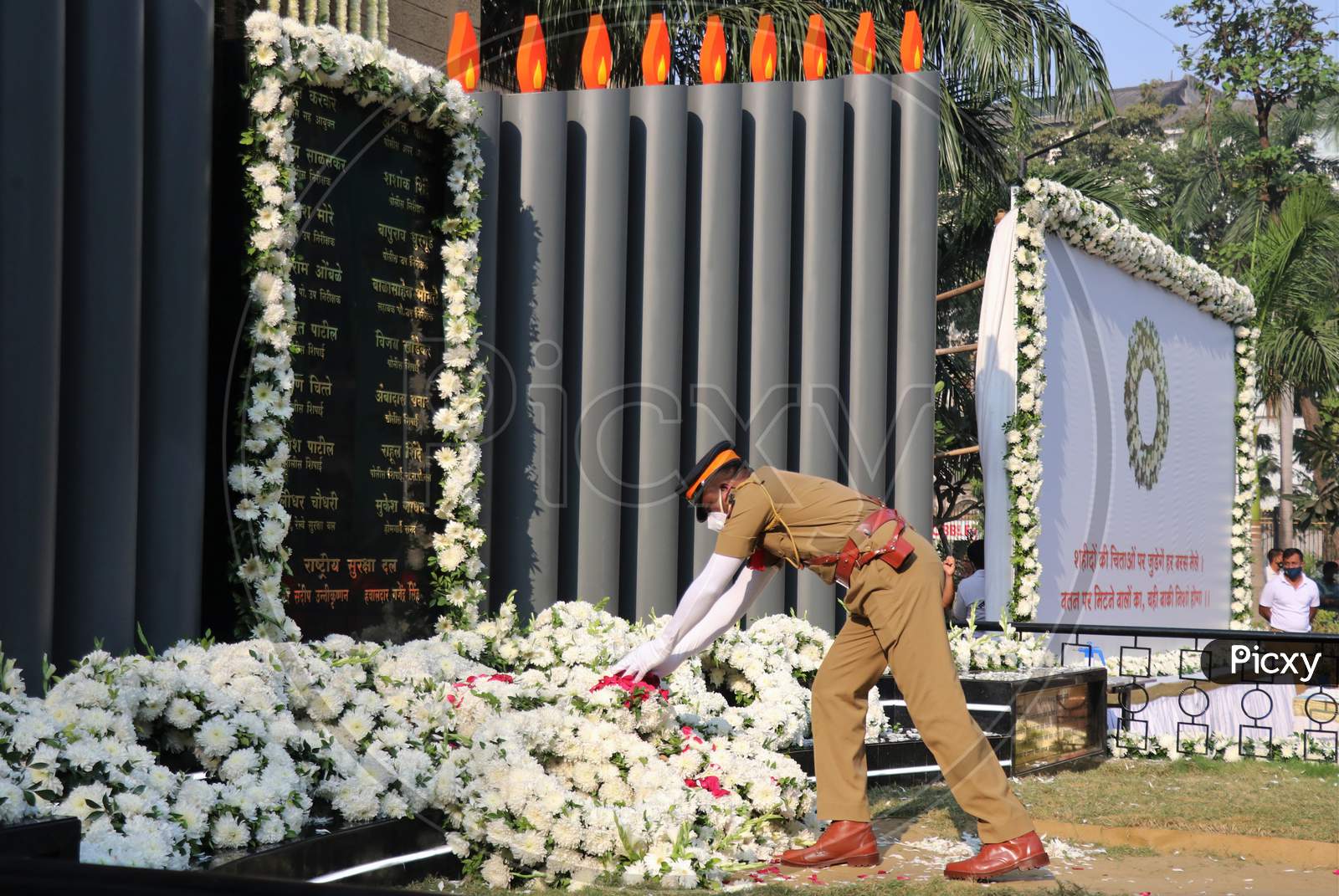 A police officer pays his respects at a memorial to mark the 12th anniversary of the November 26, 2008 attacks, in Mumbai, India November 26, 2020.