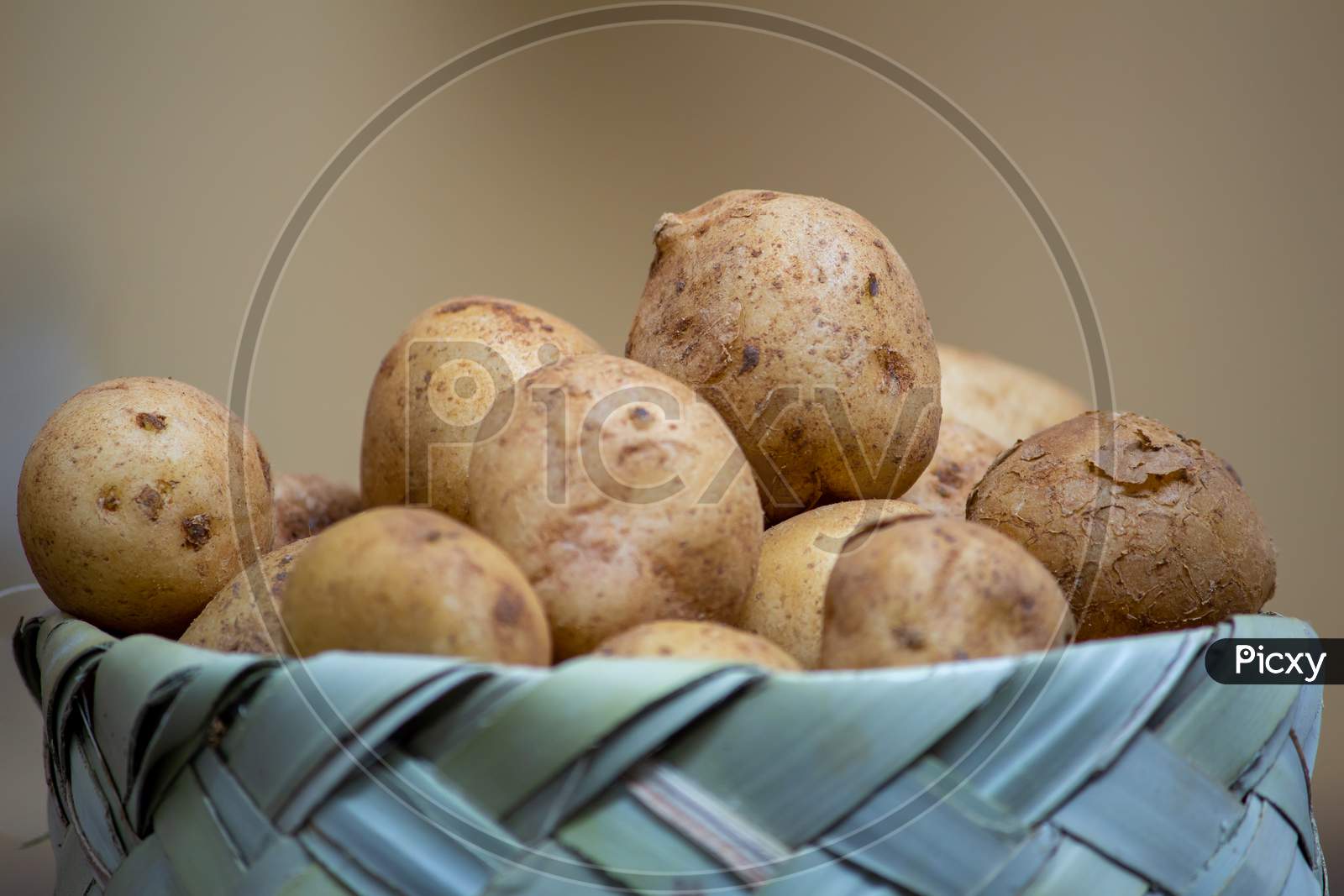 View Of Small Round Potatoes In A Basket. Market Stall Selling Small Potatoes.