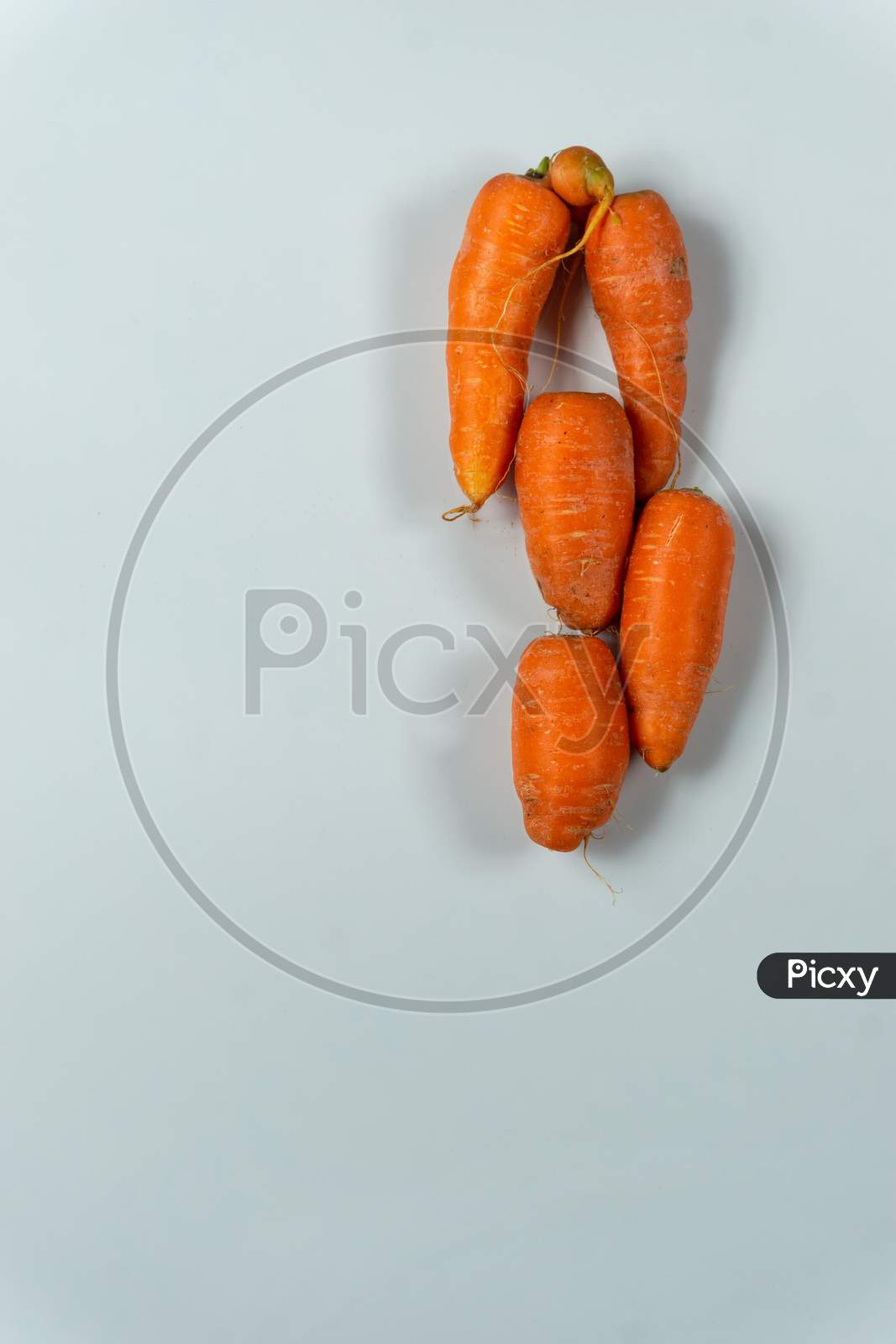 Fresh Raw Red Carrots Stacked Together On A White Background