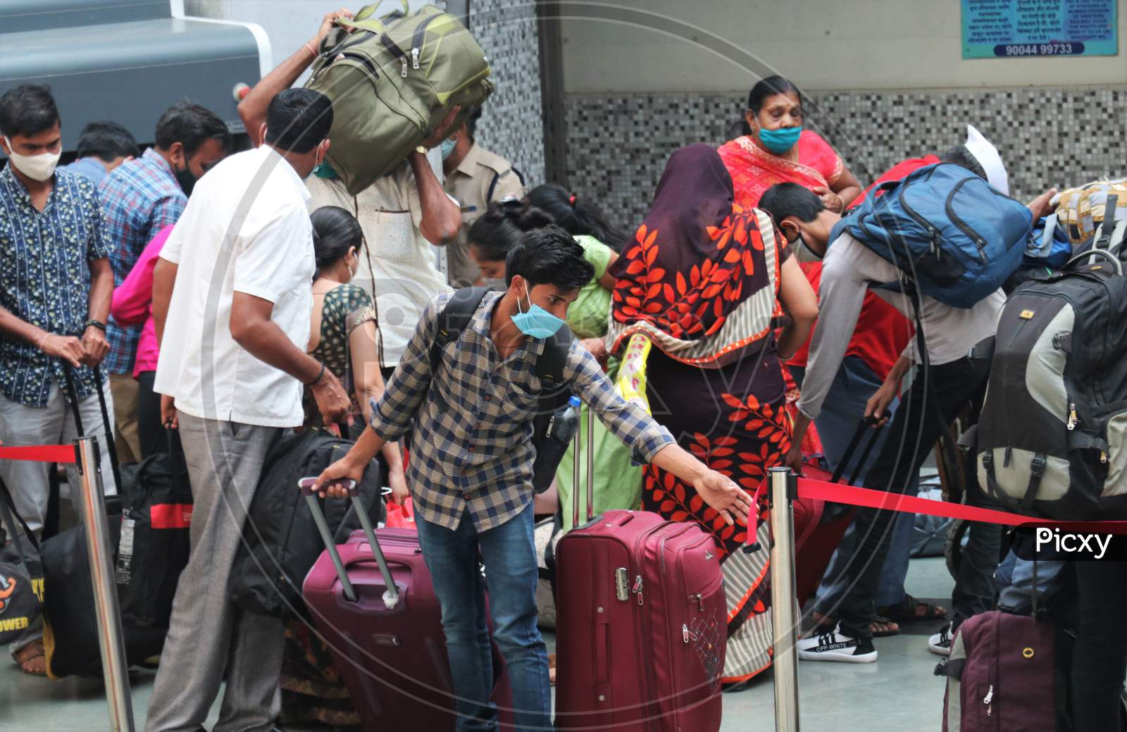 People wearing protective masks arrive at a railway station, amid the spread of the coronavirus disease (COVID-19), in Mumbai, India, November, 2020.