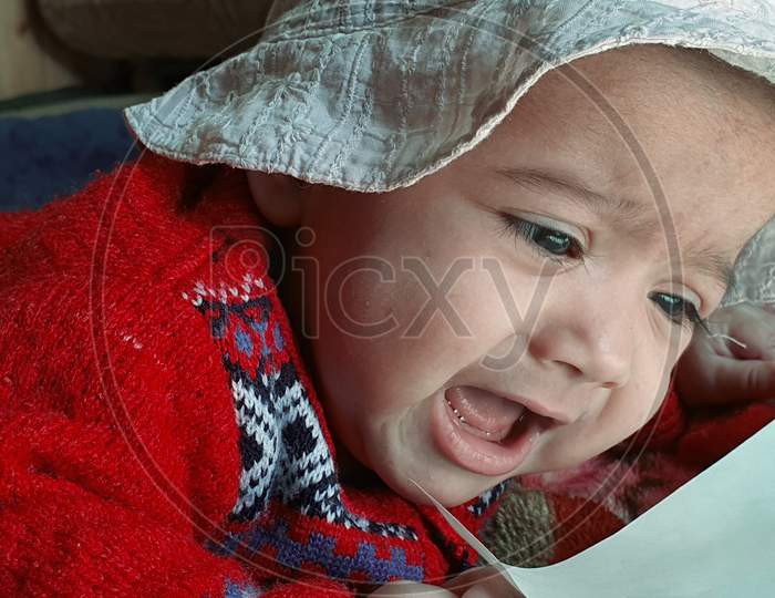 New Born Child Under Blanket At Home Asian Color Looks Very Beautiful.