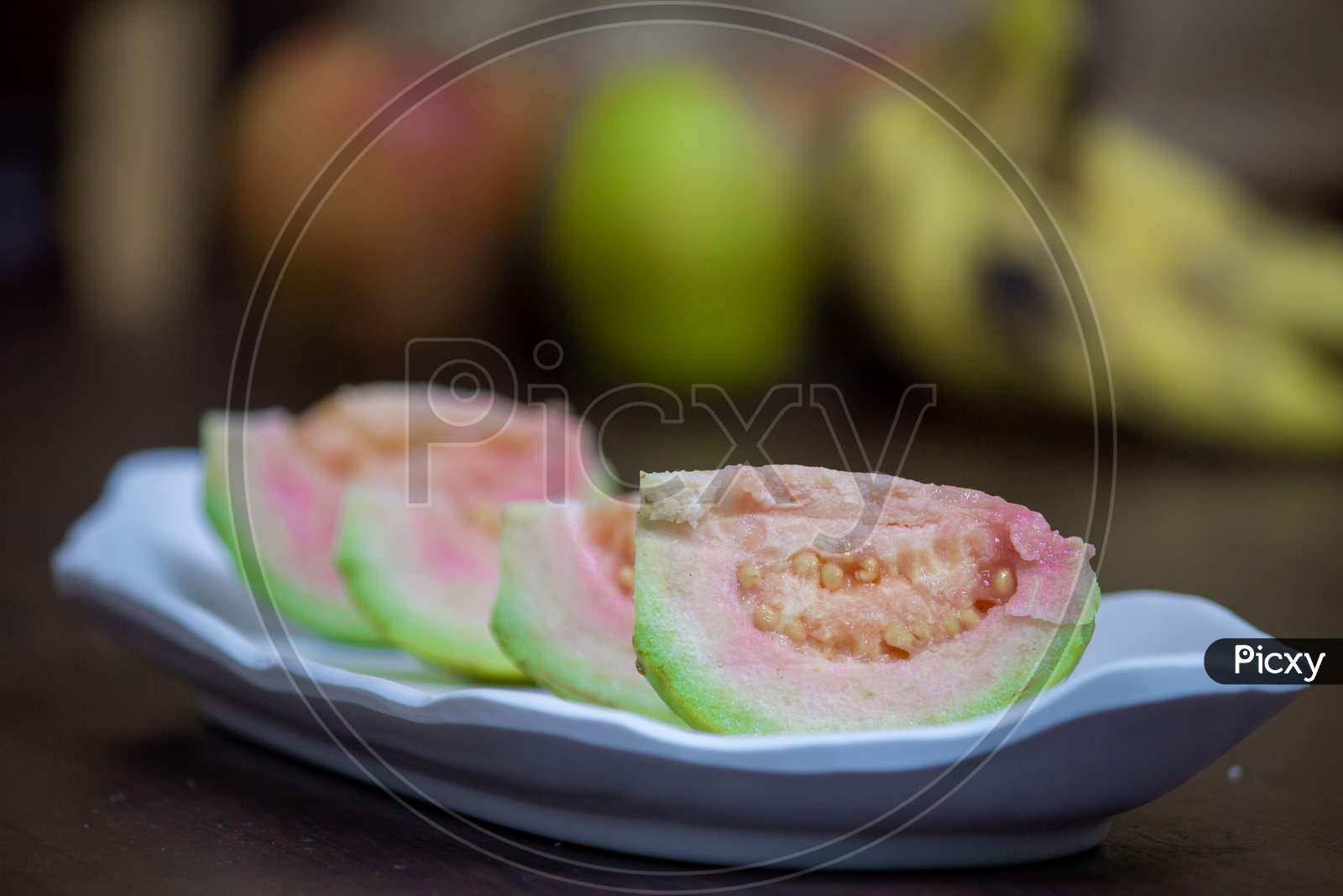 Slices Of Guava Fruit In A Plate. Guava Is A Tropical Fruit Which Are Rich In Dietary Fiber And Vitamin C