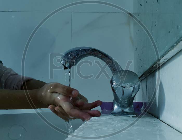 Masked Children Washing Hands During Coronavirus Pandemic. Hand Wash Mask Wearing And Using Sanitiser Are Recommended By World Health Organisation.