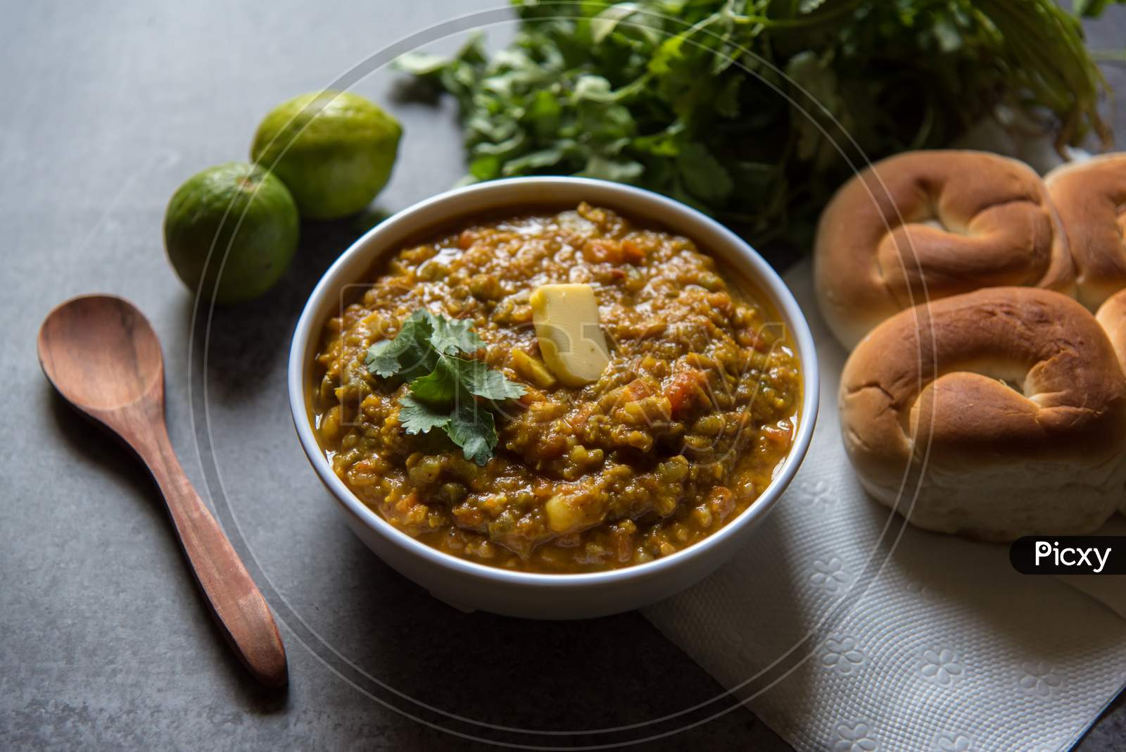 Close up of Spicy Indian dish pav bhaji or bread with masala curry along with food ingredients