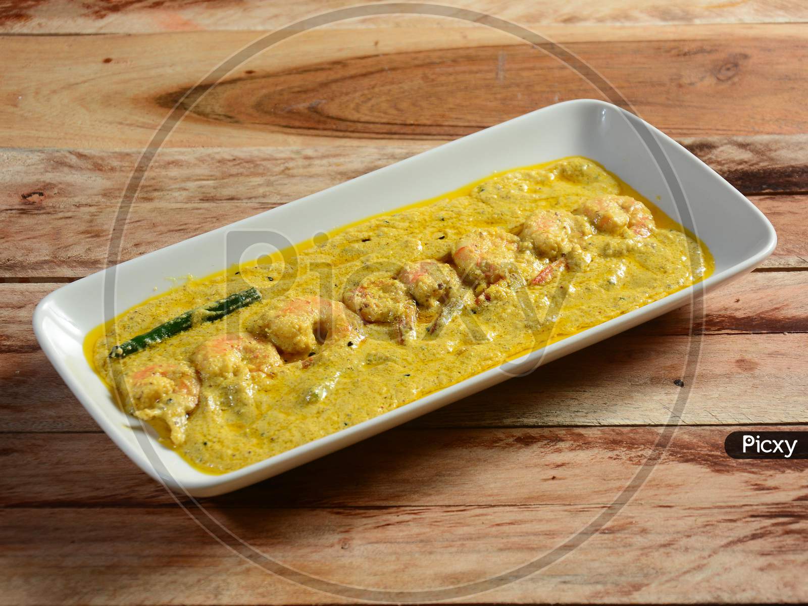 Bengali Dish Or Food - Delicious Authentic Bengali Prawn Malai Curry Also Known As Chingri Malai Curry Served On A Ceramic White Bowl, Over A Rustic Wooden Background,Selective Focus