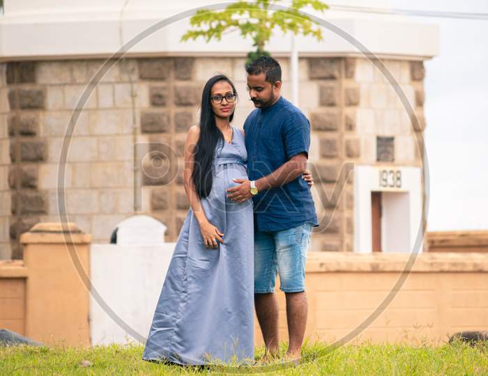 Young Cute Married South Asian Couple Pose In Galle Fort, Husband Touch Pregnant Wife'S Belly