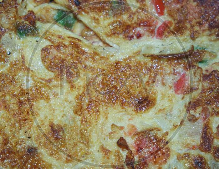 Close-Up Viewof Egg Omelet With Peppers And Spices Sprinkled