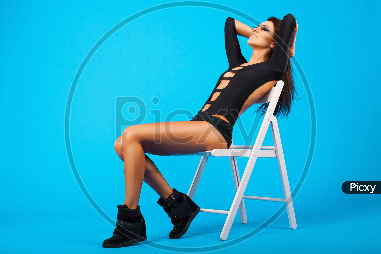 Pretty Girl In Swimsuit Sitting On A Chair