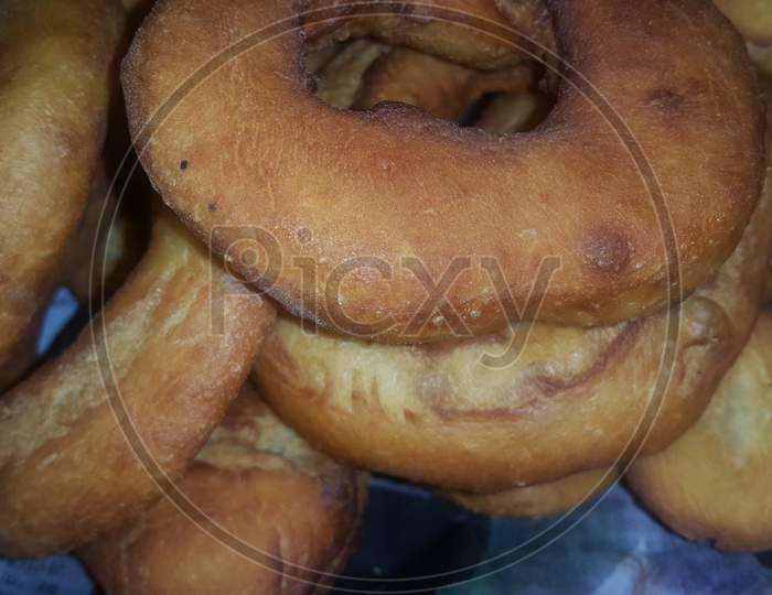 Closeup View Of A Set Of Freshly Prepared Brown And Tasty Donuts.