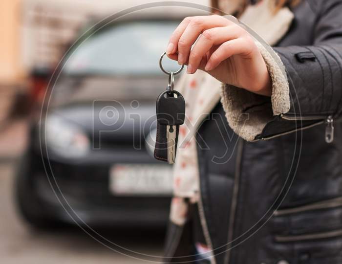 Female Hand Over The Keys Of The Car, Black Jacket