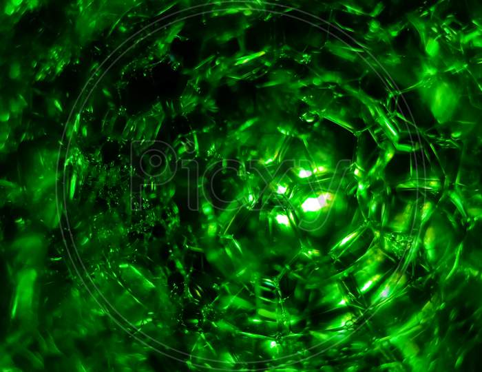 Abstract Of Green Soap Bubbles In Dark
