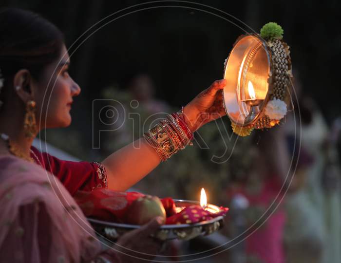 Married women perform rituals during 'Karwa Chauth' festival, in Jammu,4 November,2020.