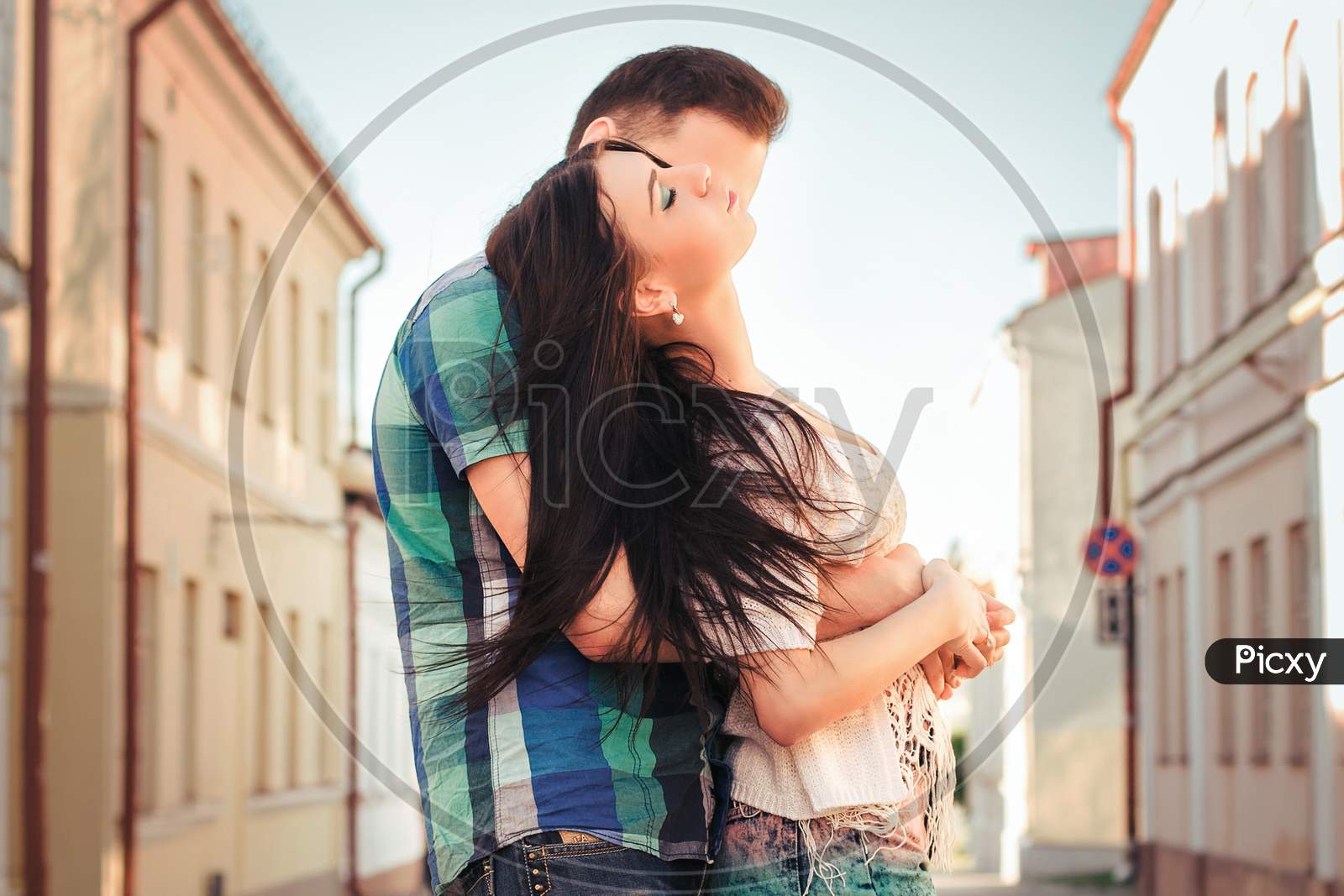 Young Couple Kissing In The Town. Love Kiss