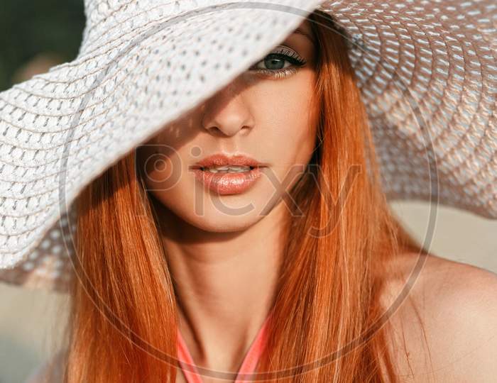 Beautiful Girl With Red Hair With A Hat On His Head