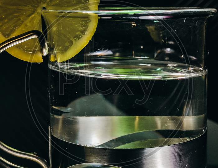 Close Up View Of Designer Glass With Slice Of A Lemon At The Top
