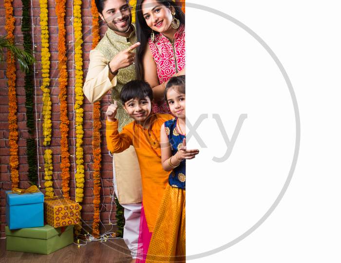 Indian Family Celebrating Diwali Festival Holding Blank White Board Or Placard