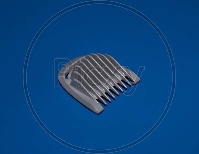 Hair Trimmer Isolated On The Blue Background. Beard And Hair Clippers.