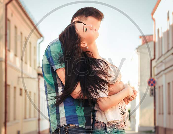 Young Couple Kissing In The Town. Love Kiss