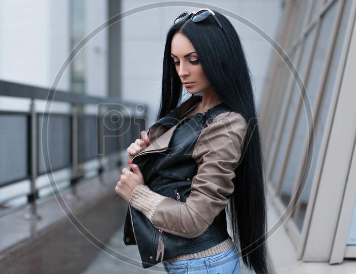 Girl In A Leather Jacket Standing Near The Building