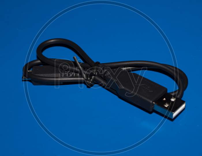 Usb And Micro Usb Cable Blue Background.