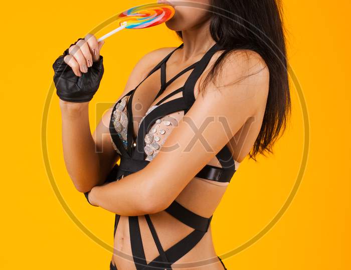 Pretty Woman In Swimsuit Holding A Candy In The Hands Of