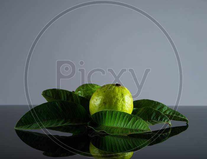 Guava Fruit And Its Leaves On A Black And White Background