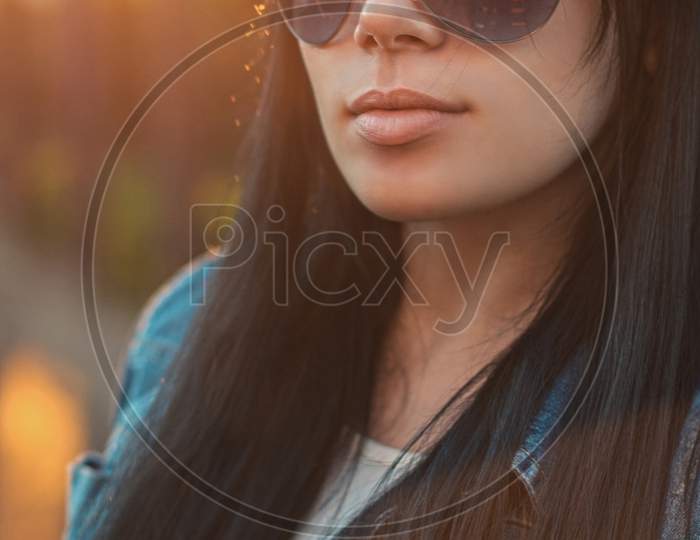 Beautiful Girl In Sunglasses. Sunlight  Sunset