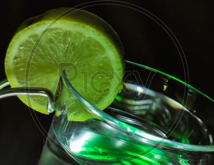 Close Up View Of Designer Glass With Slice Of A Lemon At The Top