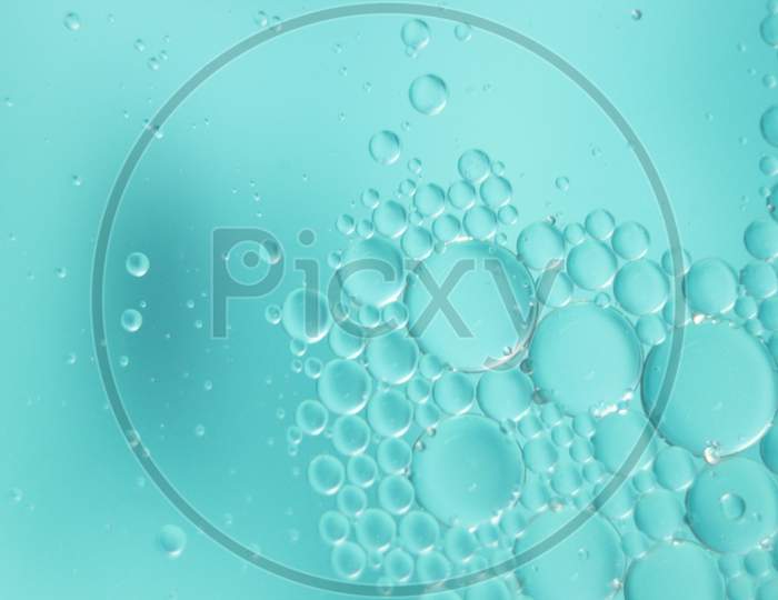 Abstract Macro Background Of Oil Circles Floating Over Water Surface .