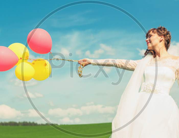 Bride Is Holding Balloons In Hands.
