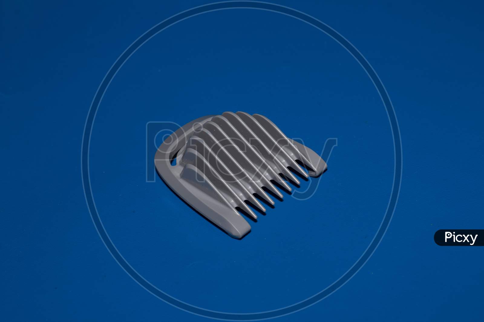 Hair Trimmer Isolated On The Blue Background. Beard And Hair Clippers.