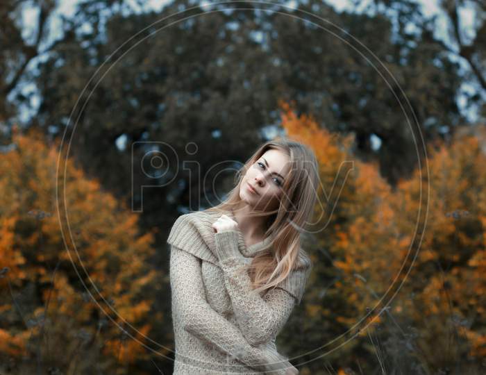 Girl In A Sweater Standing In A Field