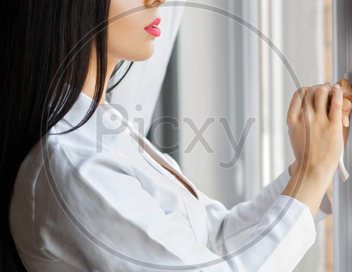 Beautiful Woman Opens A Window