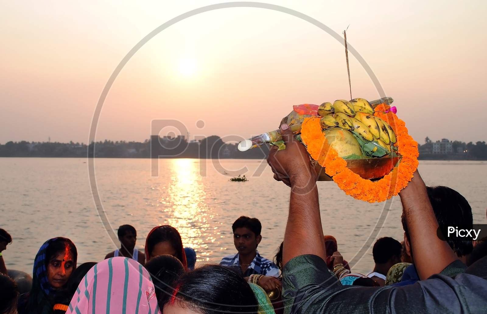 A Hindu devotee offering his puja to the Sun God.