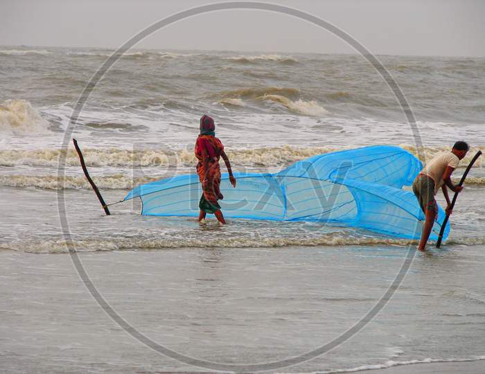 Local fishermen with fish trap at Bakkhali sea beach