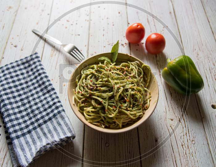 Close up of  spaghetti with pesto sauce in a bowl