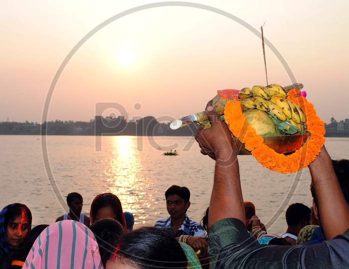 A Hindu devotee offering his puja to the Sun God.