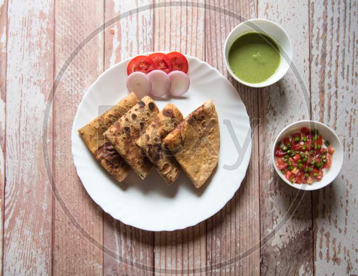 Top view of Indian popular breakfast dish alu paratha in a plate.