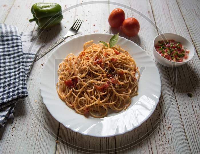 Close up of spaghetti with tomato sauce and basil